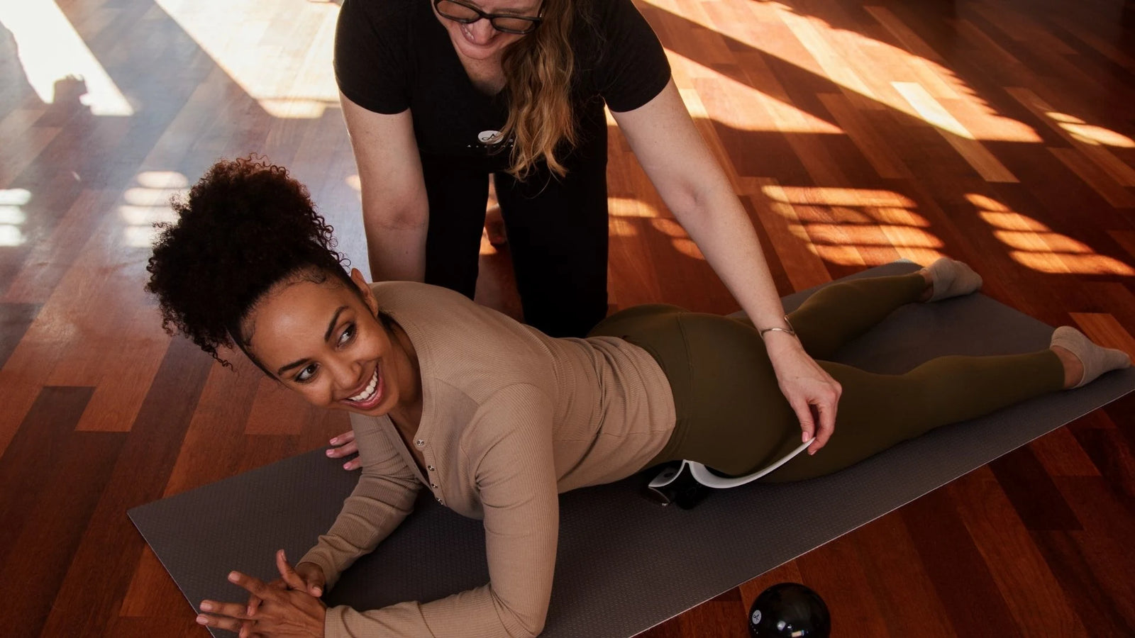 Christine guiding a woman through Hip Hook placement